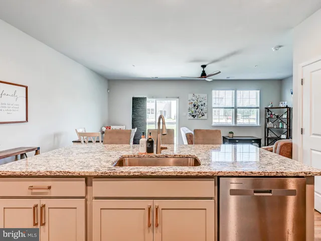 a kitchen with granite countertop a sink and a wooden floor