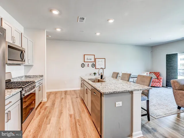 a kitchen with a sink stove and refrigerator