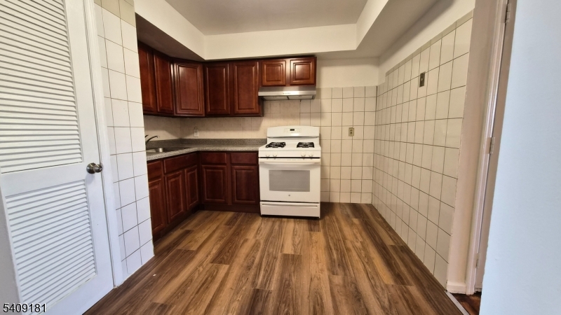 536 Livingston Street Elizabeth Port, NJ 07206 - Photo 12 of 14 a kitchen with a sink a stove and cabinets