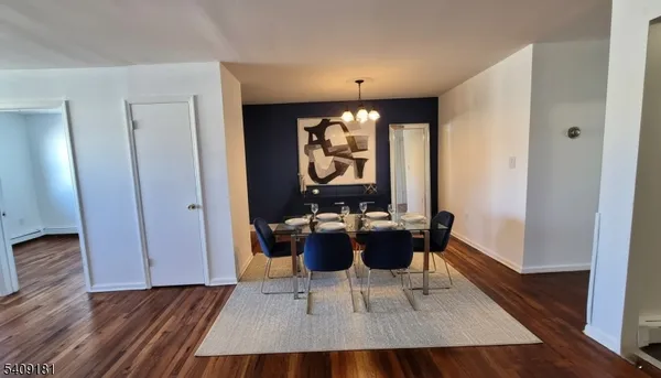a dining room with furniture and wooden floor