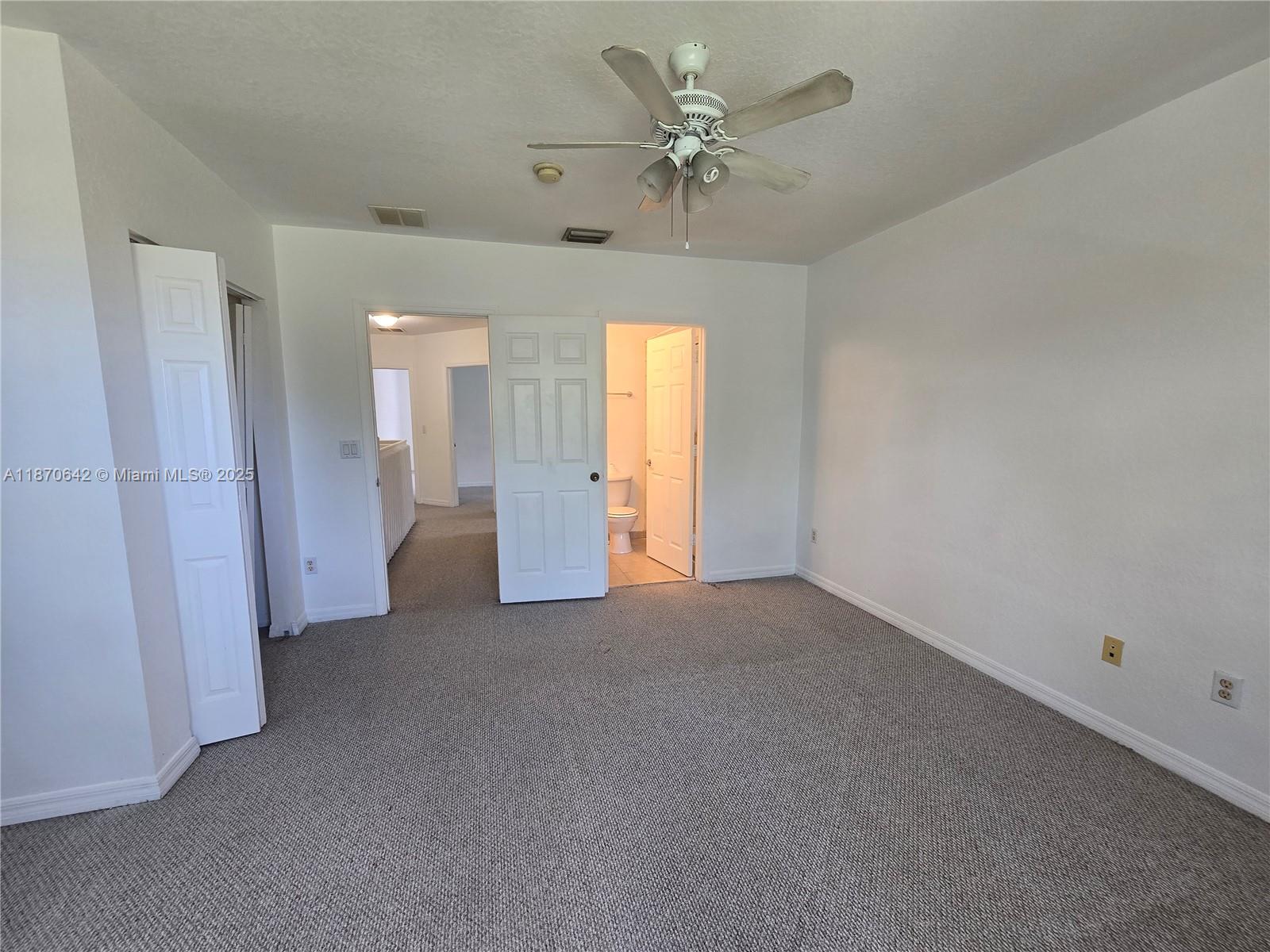 3632 Oleander Terrace, Unit 3632 Riviera Beach, FL 33404 - Photo 11 of 26 a view of a big room with chandelier fan and windows