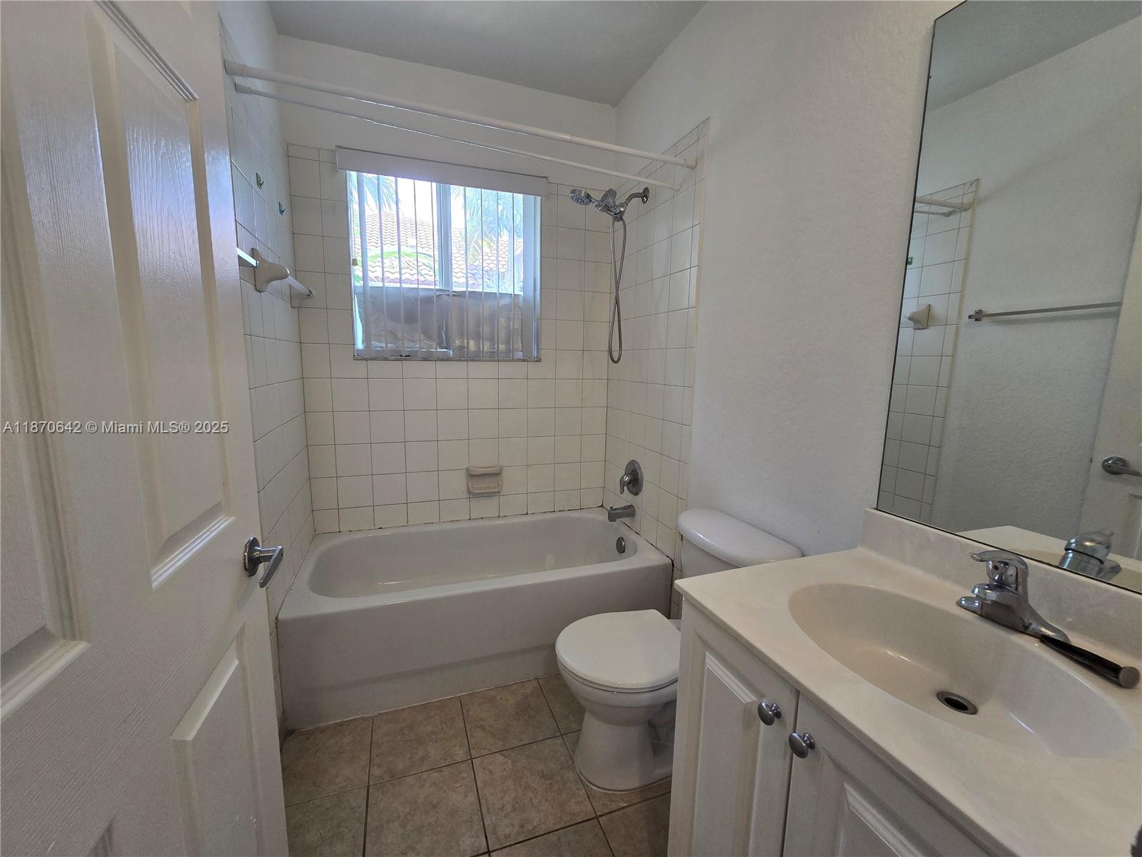 3632 Oleander Terrace, Unit 3632 Riviera Beach, FL 33404 - Photo 13 of 26 a bathroom with a sink toilet vanity and shower