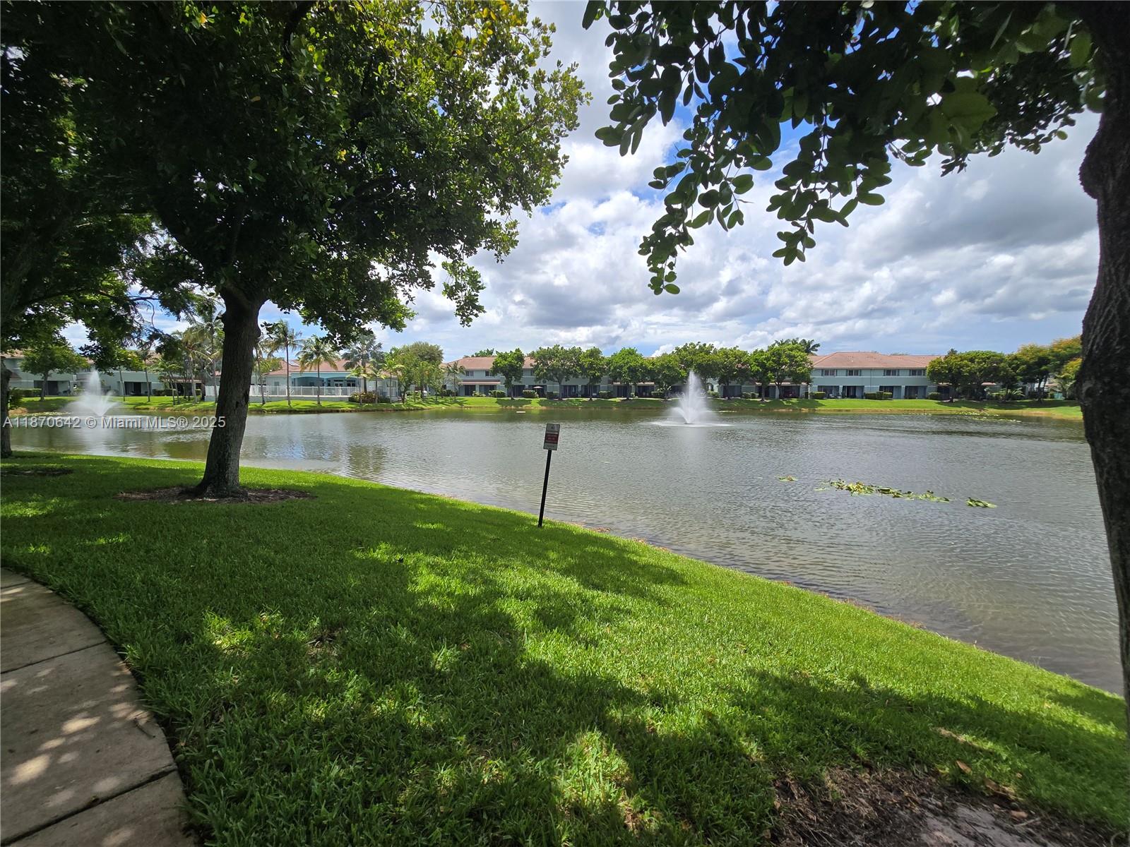 3632 Oleander Terrace, Unit 3632 Riviera Beach, FL 33404 - Photo 20 of 26 a view of a lake with houses in the back