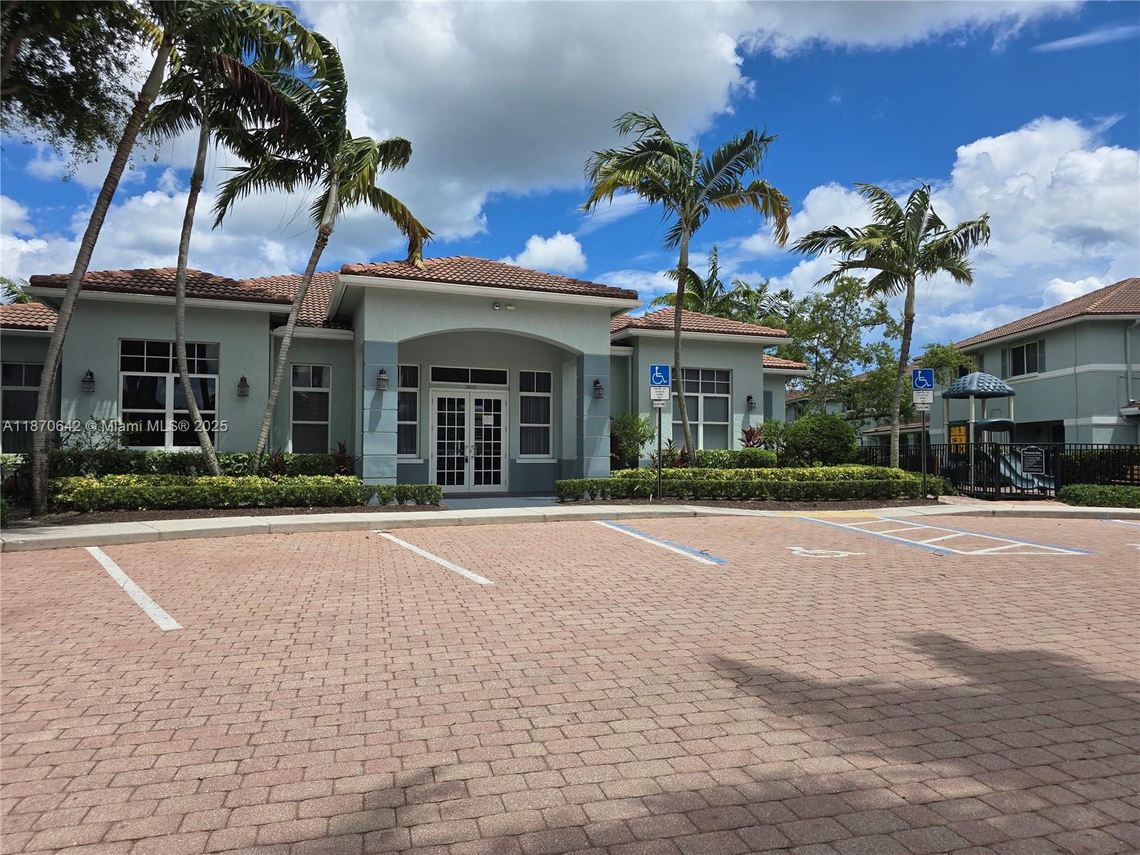3632 Oleander Terrace, Unit 3632 Riviera Beach, FL 33404 - Photo 22 of 26 front view of a house with a garden