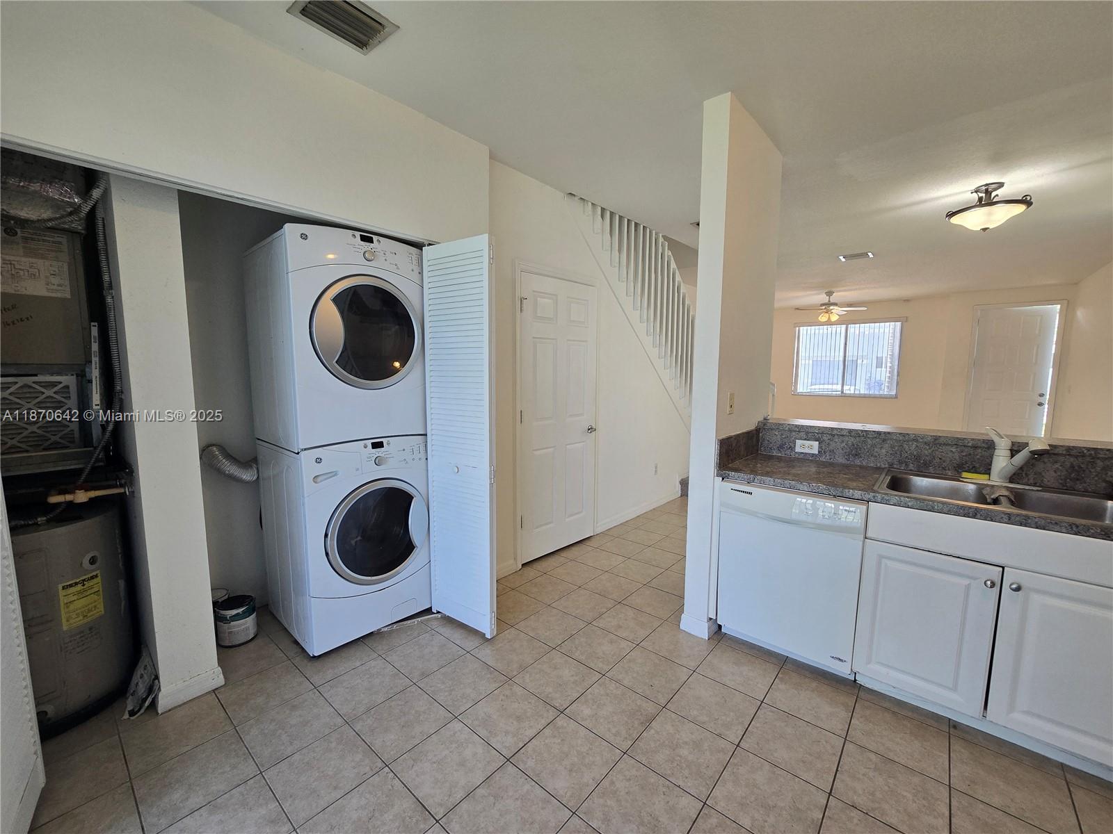 3632 Oleander Terrace, Unit 3632 Riviera Beach, FL 33404 - Photo 5 of 26 a utility room with sink dryer and washer