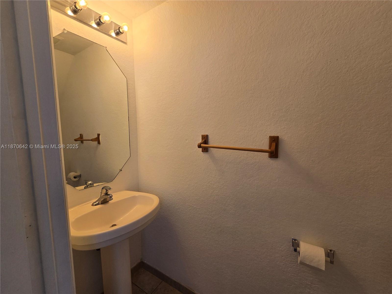 3632 Oleander Terrace, Unit 3632 Riviera Beach, FL 33404 - Photo 7 of 26 a bathroom with a sink and mirror