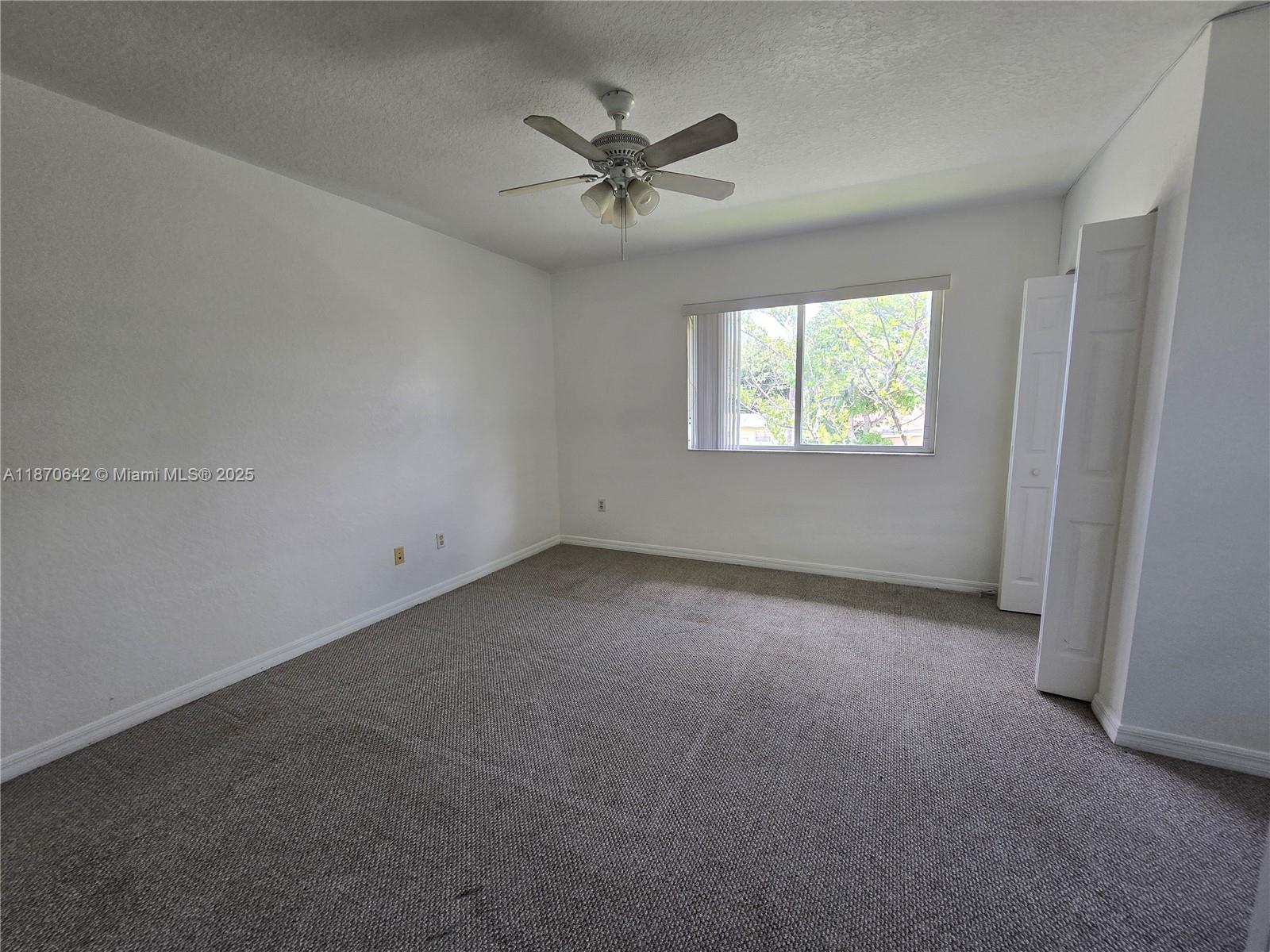3632 Oleander Terrace, Unit 3632 Riviera Beach, FL 33404 - Photo 10 of 26 an empty room with a ceiling fan and window