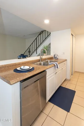 a kitchen with a sink and a stove top oven