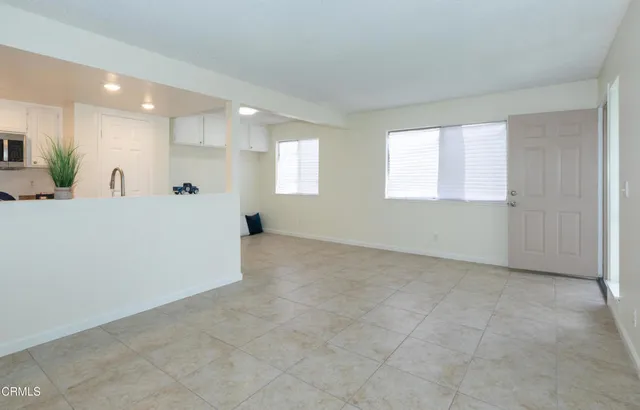 a view of a livingroom with wooden floor and staircase