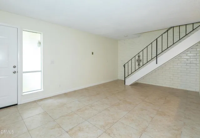 a view of kitchen with refrigerator and cabinets