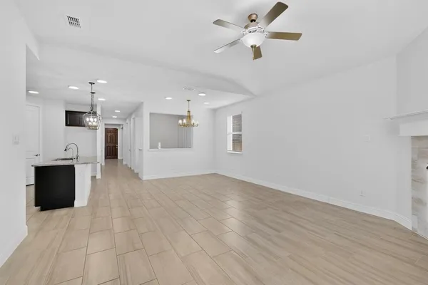 a kitchen with kitchen island granite countertop a sink appliances and cabinets