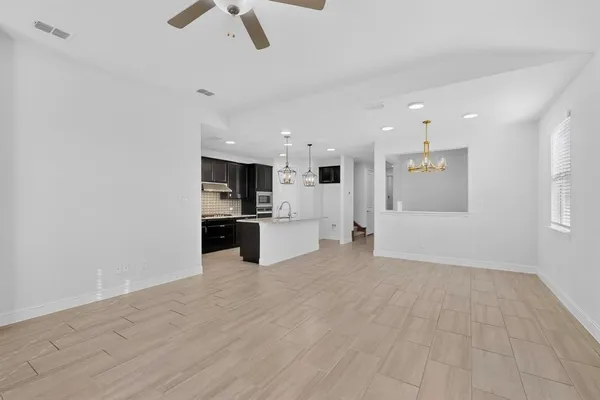 a kitchen with stainless steel appliances granite countertop a sink dishwasher a refrigerator and a stove