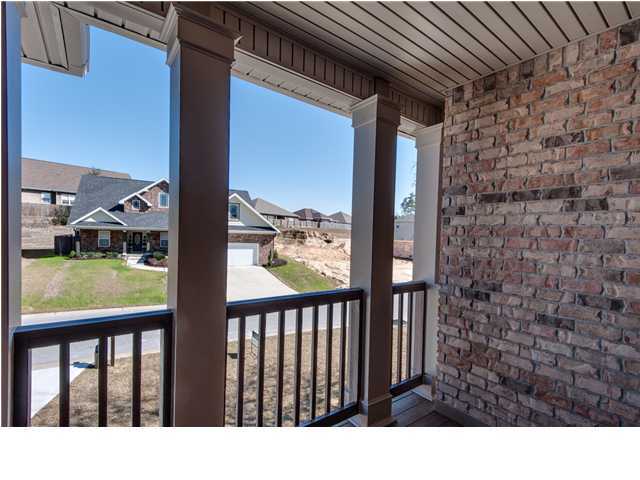 4560 Hermosa Road Crestview, FL 32539 - Photo 16 of 26 a view of a balcony with a floor to ceiling window stairs and an outdoor view
