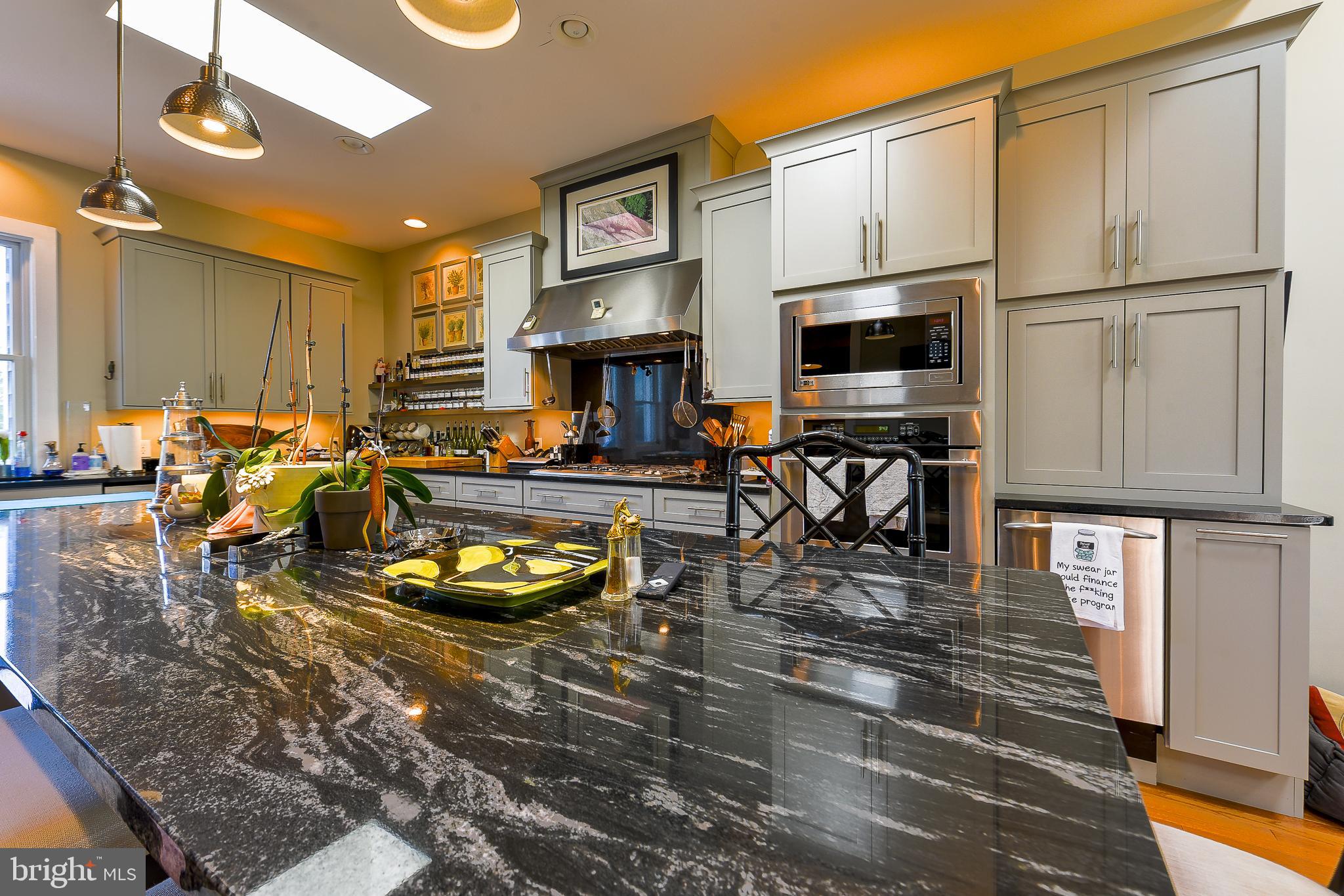 38520 Pine Lane, Unit 2 Rehoboth Beach, DE 19971 - Photo 17 of 71 a kitchen with stainless steel appliances granite countertop a stove refrigerator and a microwave