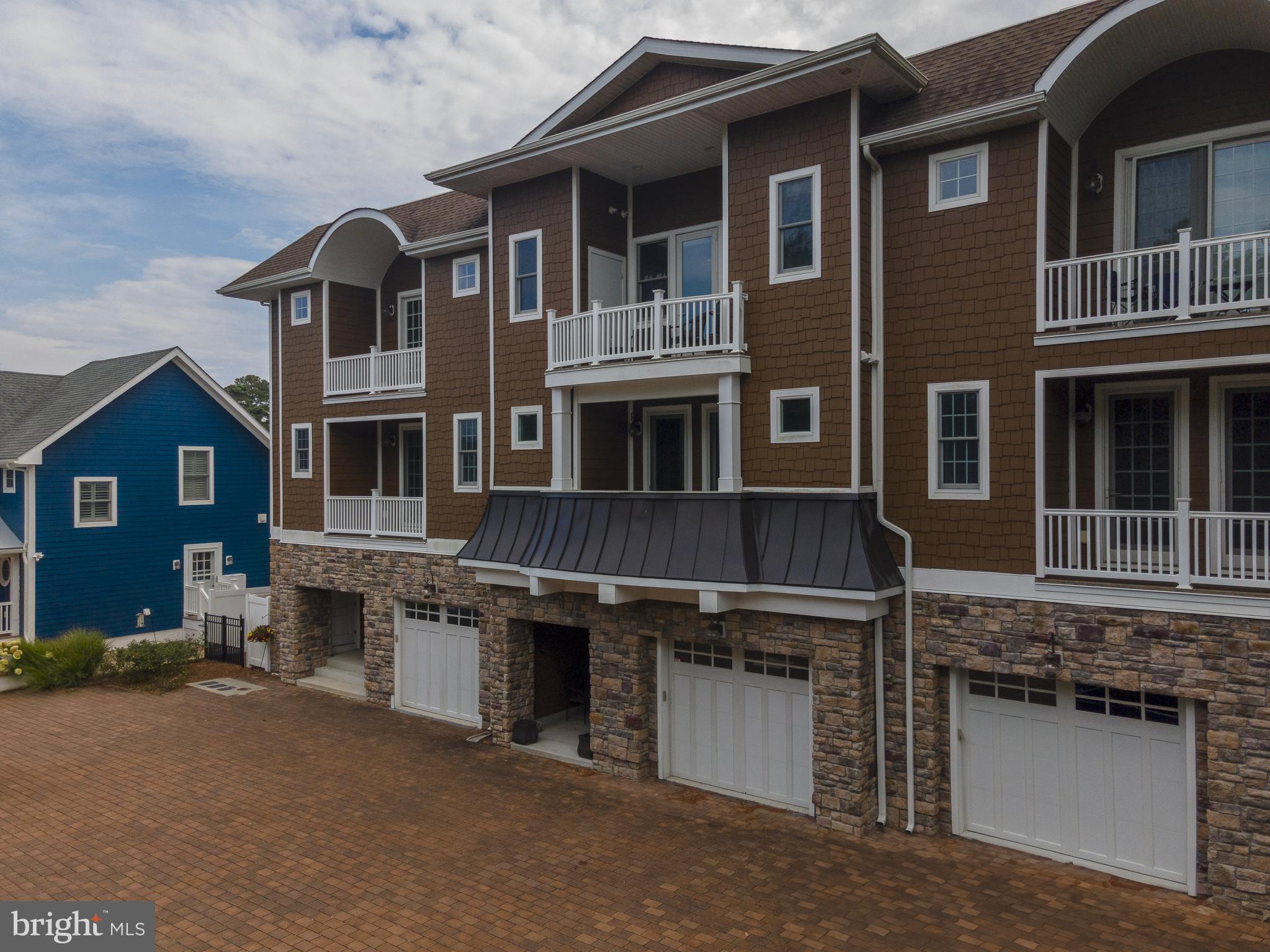 38520 Pine Lane, Unit 2 Rehoboth Beach, DE 19971 - Photo 2 of 71 a front view of a house with a garage