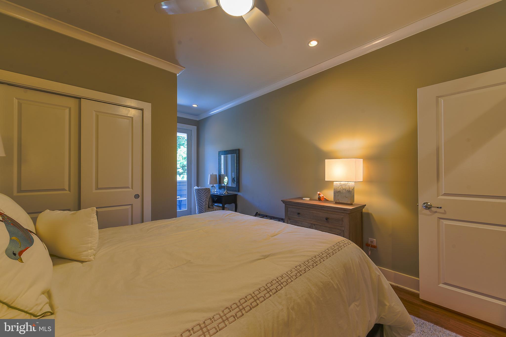 38520 Pine Lane, Unit 2 Rehoboth Beach, DE 19971 - Photo 24 of 71 a bedroom with a bed and a large mirror on dresser