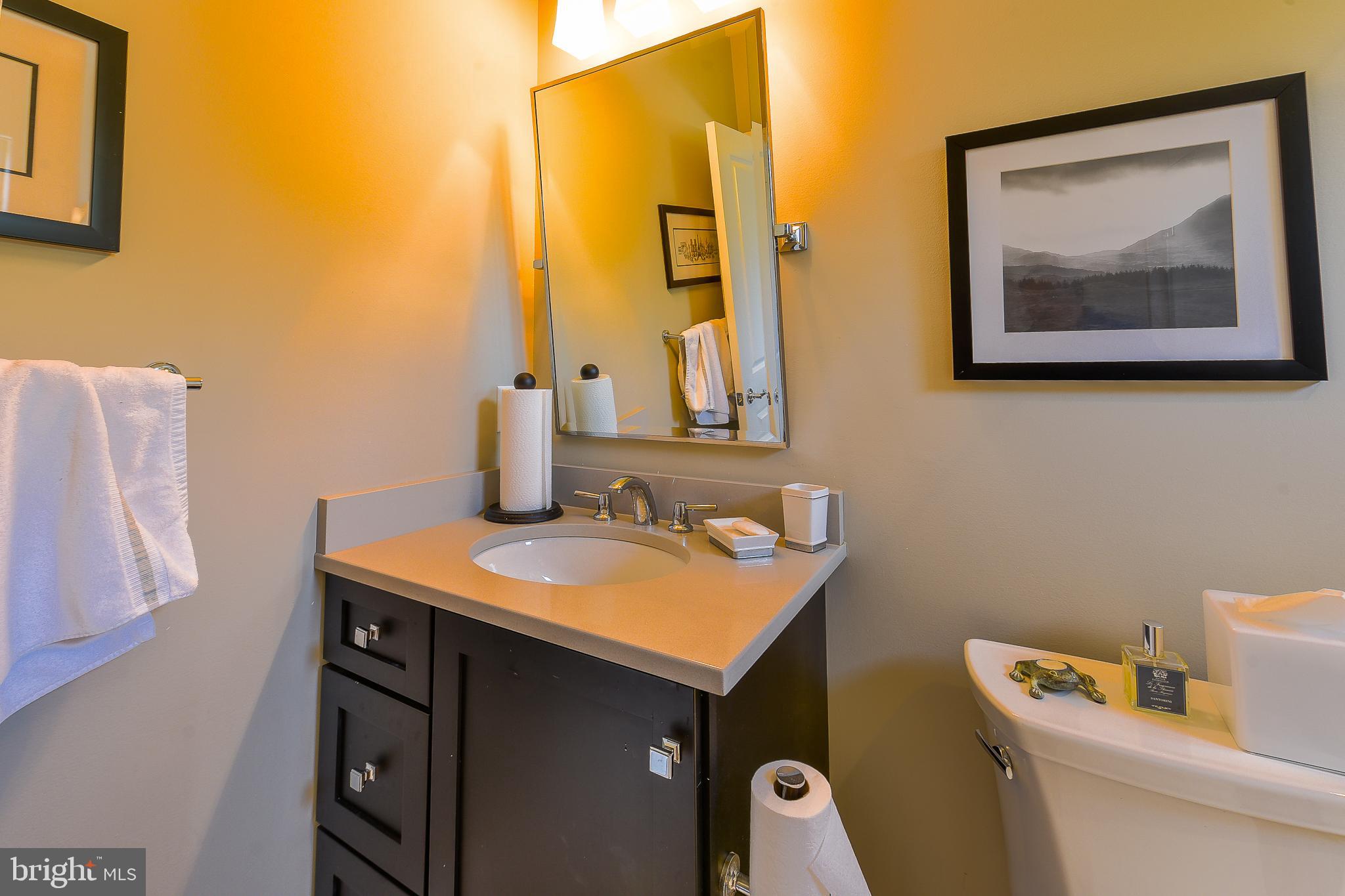 38520 Pine Lane, Unit 2 Rehoboth Beach, DE 19971 - Photo 29 of 71 a bathroom with a toilet sink and mirror