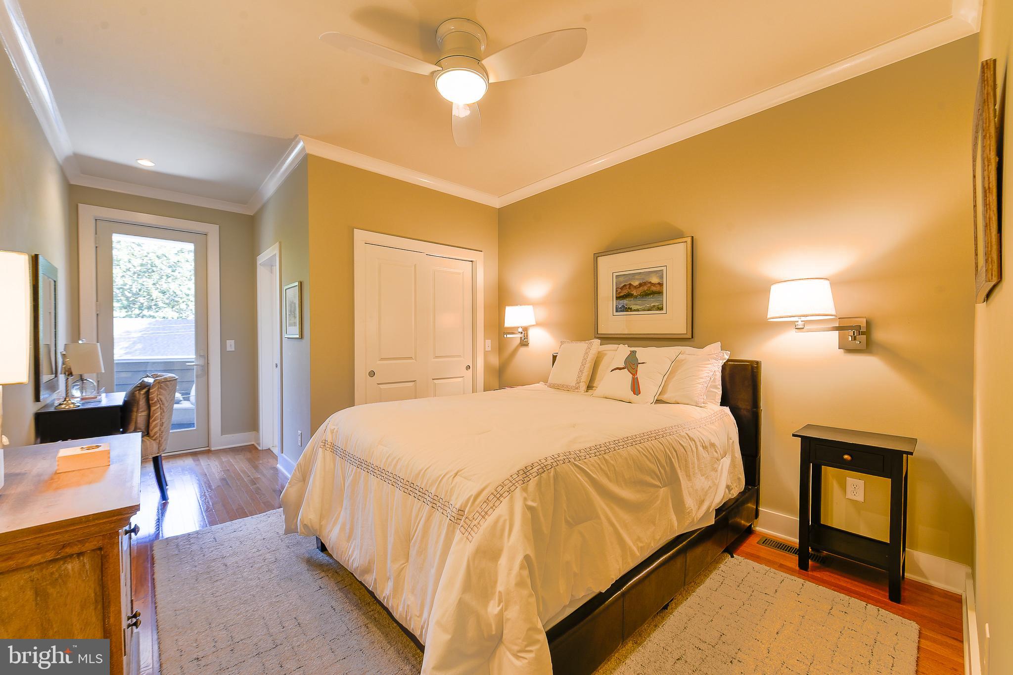 38520 Pine Lane, Unit 2 Rehoboth Beach, DE 19971 - Photo 31 of 71 a spacious bedroom with a bed and dresser with mirror