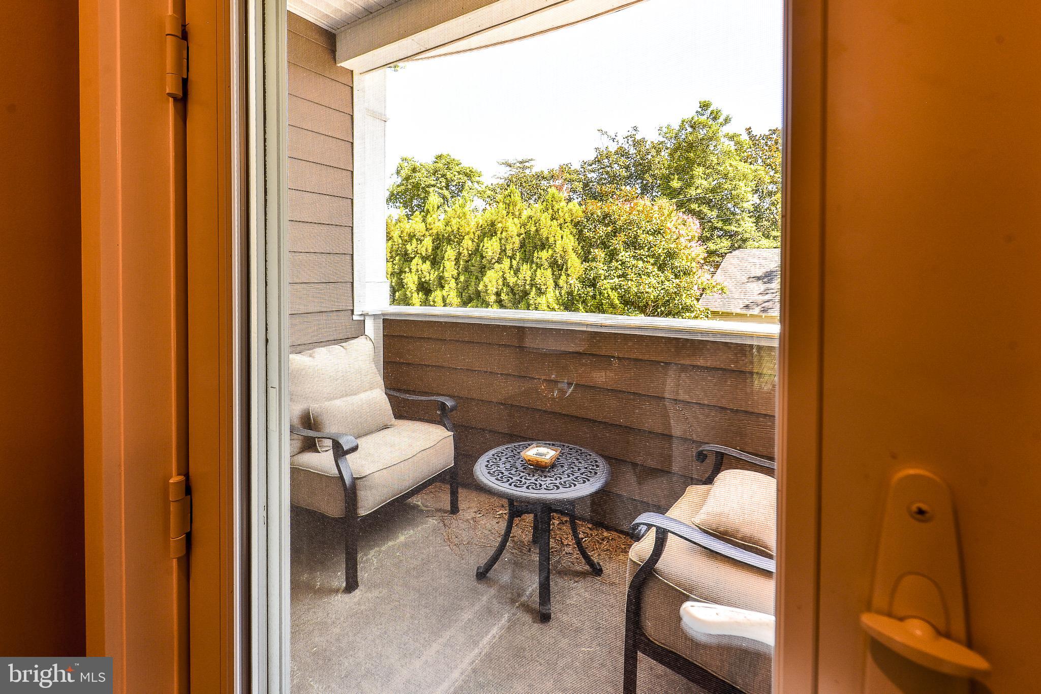 38520 Pine Lane, Unit 2 Rehoboth Beach, DE 19971 - Photo 34 of 71 a view of a balcony with chairs and a table