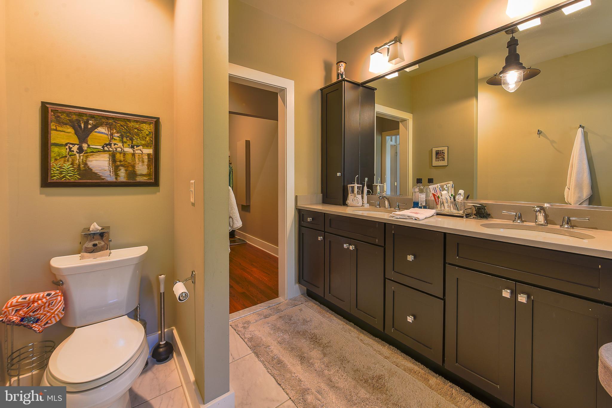 38520 Pine Lane, Unit 2 Rehoboth Beach, DE 19971 - Photo 46 of 71 a bathroom with a toilet sink and mirror