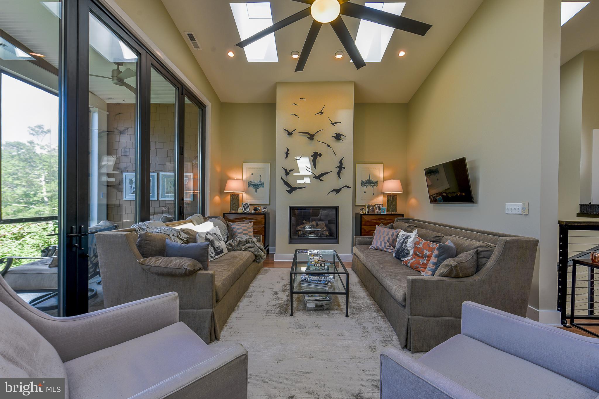 38520 Pine Lane, Unit 2 Rehoboth Beach, DE 19971 - Photo 5 of 71 a living room with furniture a fireplace and a flat screen tv