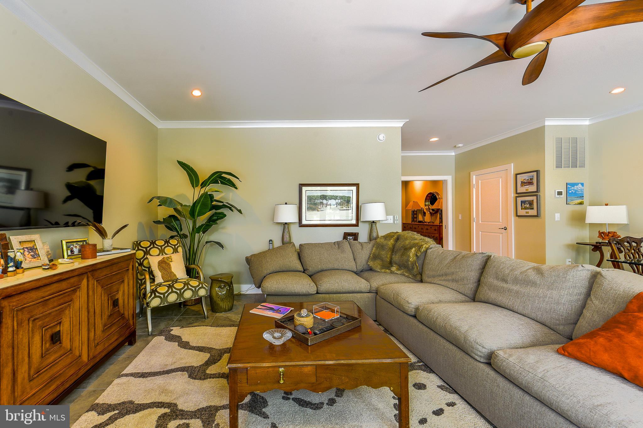 38520 Pine Lane, Unit 2 Rehoboth Beach, DE 19971 - Photo 55 of 71 a living room with furniture a flat screen tv and kitchen view