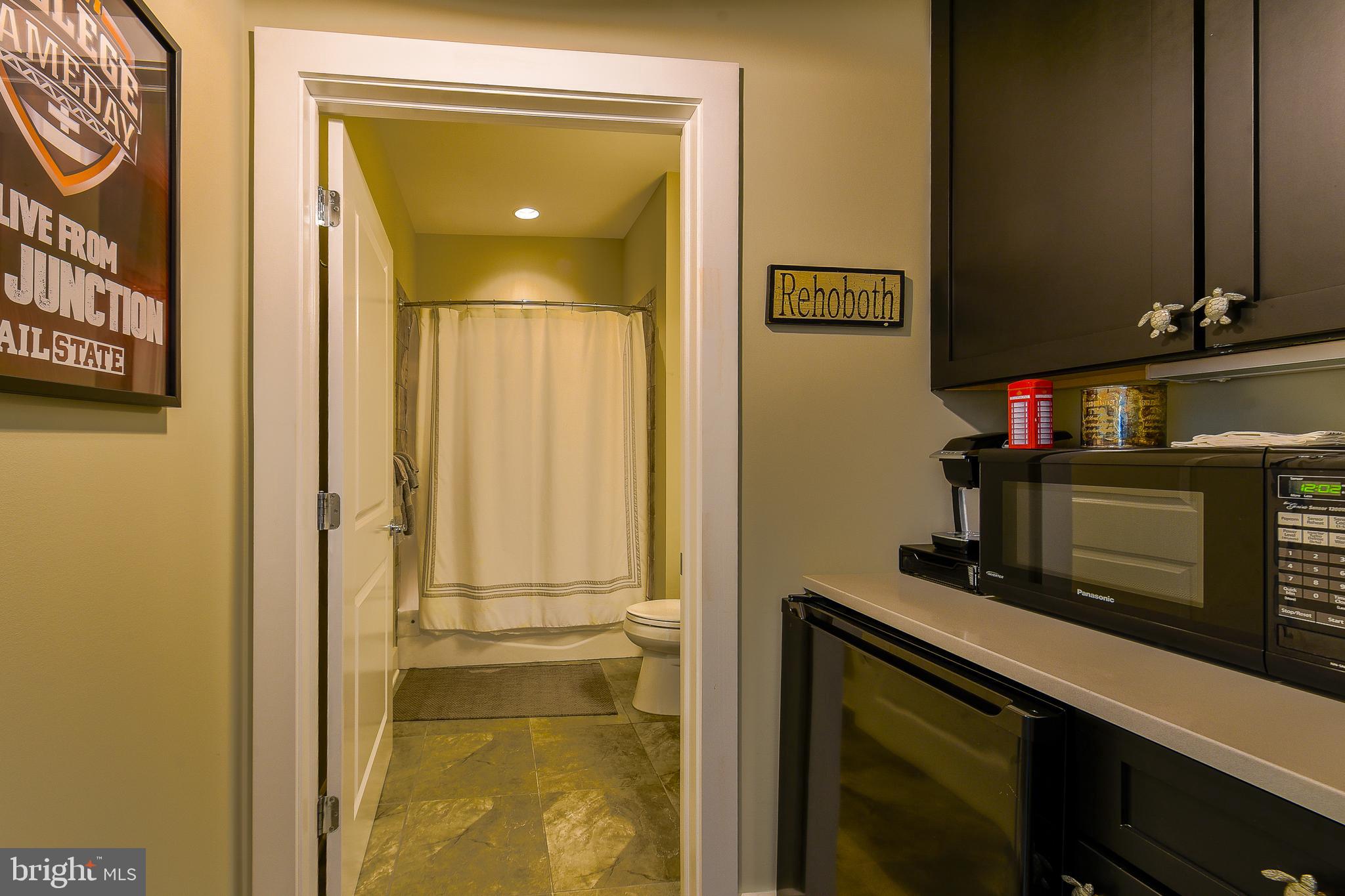 38520 Pine Lane, Unit 2 Rehoboth Beach, DE 19971 - Photo 61 of 71 a bathroom with a sink and a mirror