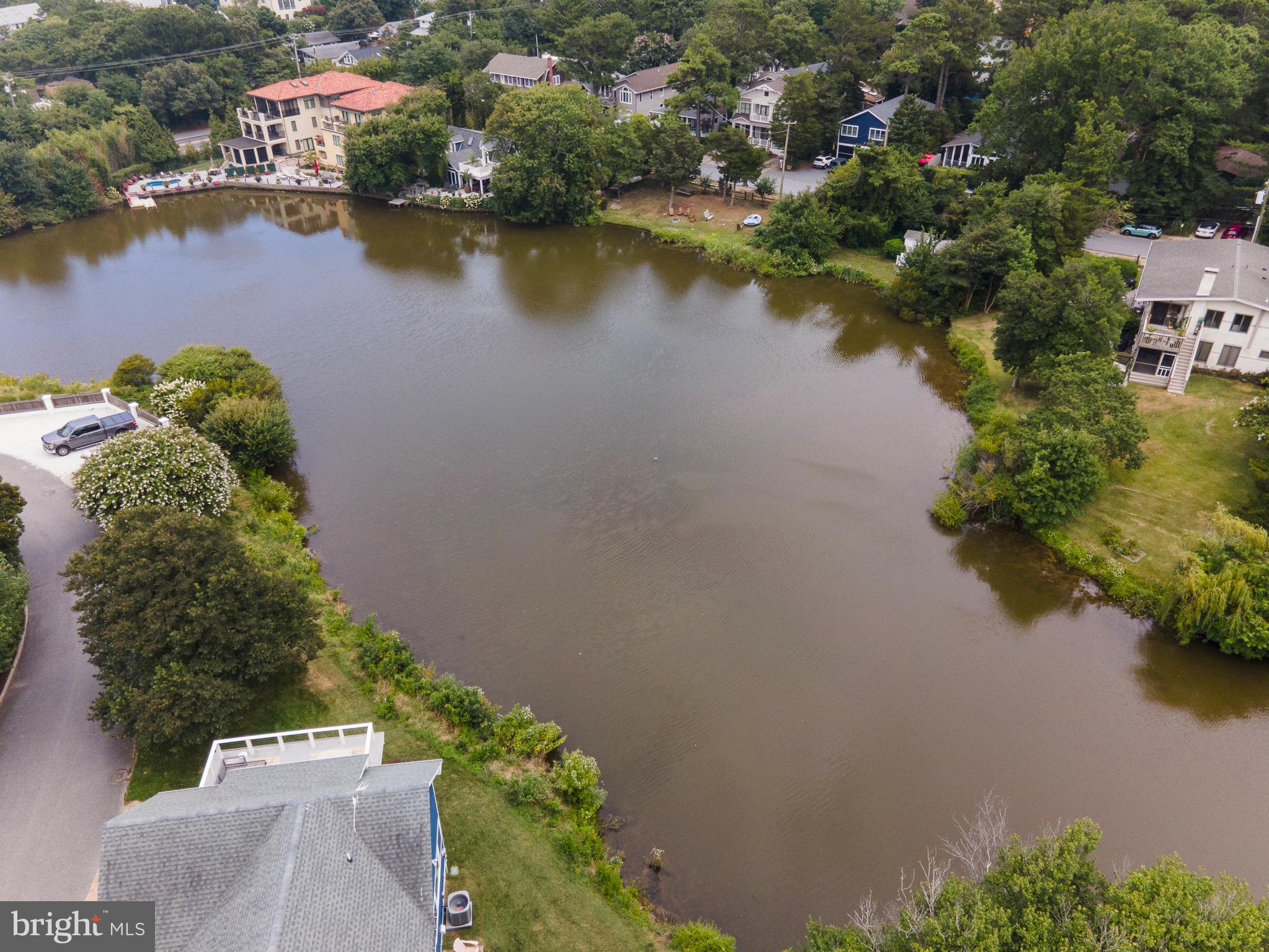 38520 Pine Lane, Unit 2 Rehoboth Beach, DE 19971 - Photo 64 of 71 an aerial view of residential houses with outdoor space and lake view