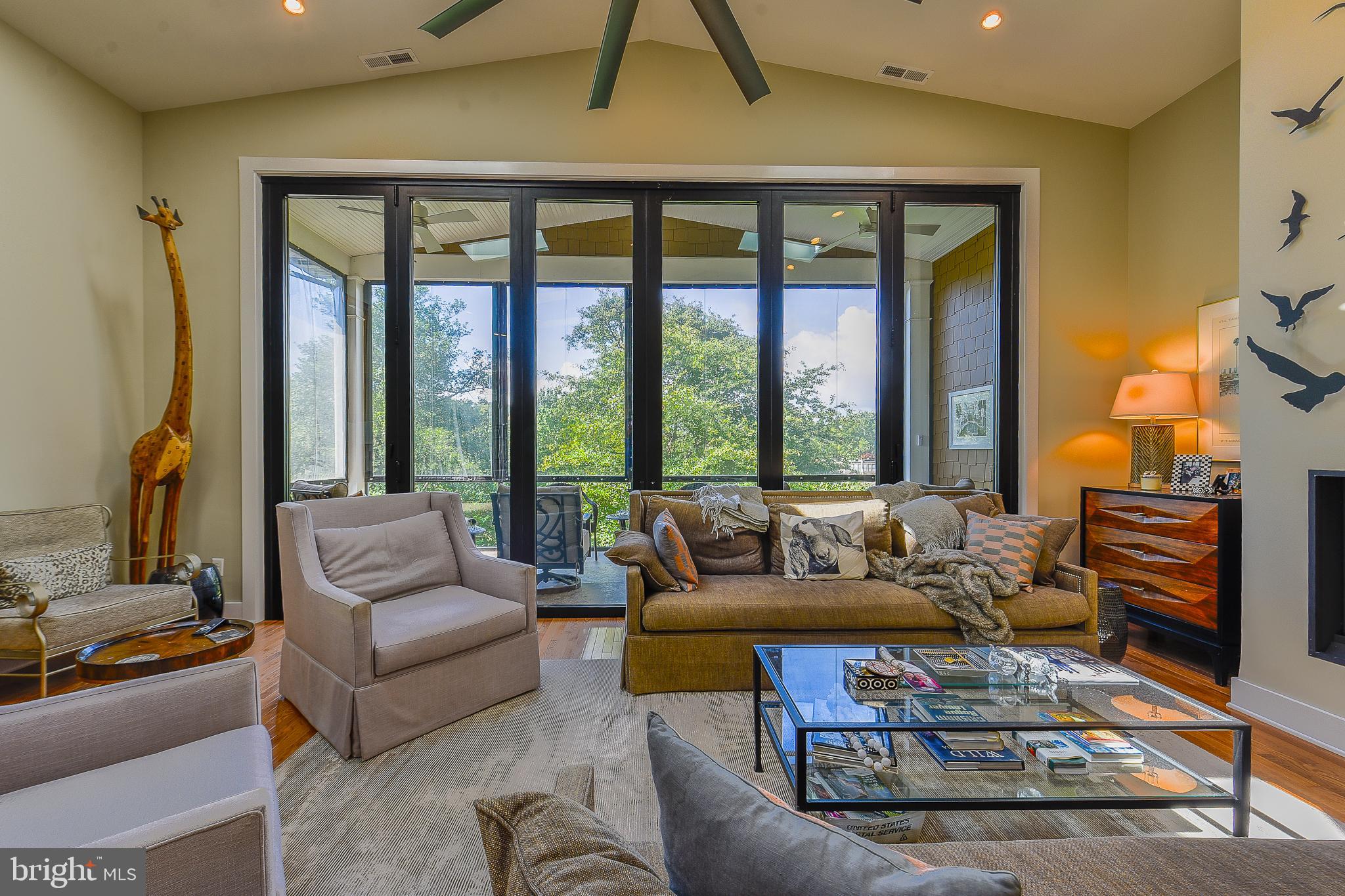 38520 Pine Lane, Unit 2 Rehoboth Beach, DE 19971 - Photo 7 of 71 a living room with furniture and a floor to ceiling window