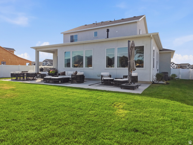2559 West Aurora Avenue Mapleton, UT 84664 - Photo 58 of 60 Spacious backyard featuring an expansive lawn, a large concrete patio, and a covered patio area