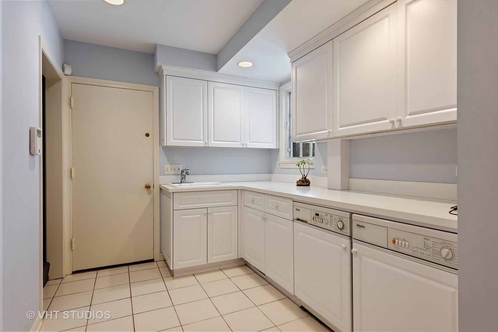 315 Woodley Road Winnetka, IL 60093 - Photo 14 of 28 a kitchen with white cabinets and white appliances