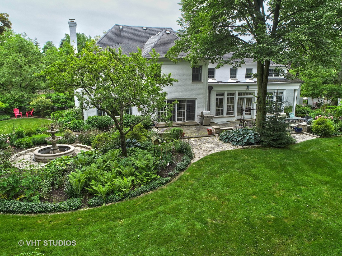 315 Woodley Road Winnetka, IL 60093 - Photo 22 of 28 a front view of a house with a yard and fountain