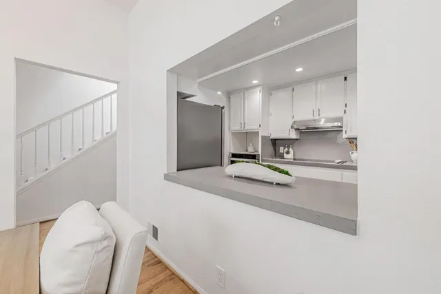 a view of a dining room with furniture a chandelier and wooden floor
