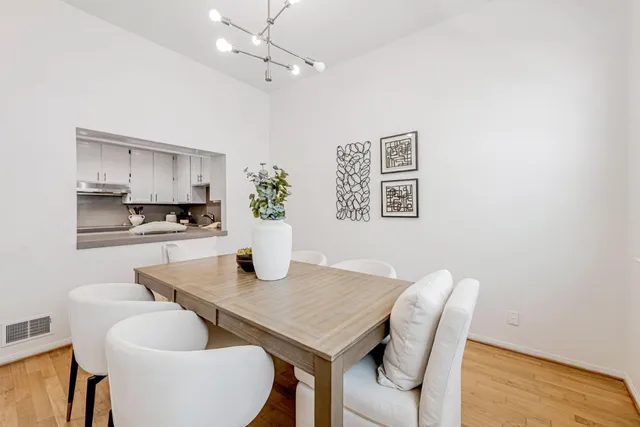 a dining room with furniture and wooden floor