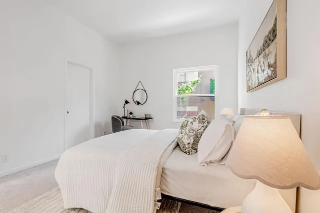 a bedroom with a bed and a window