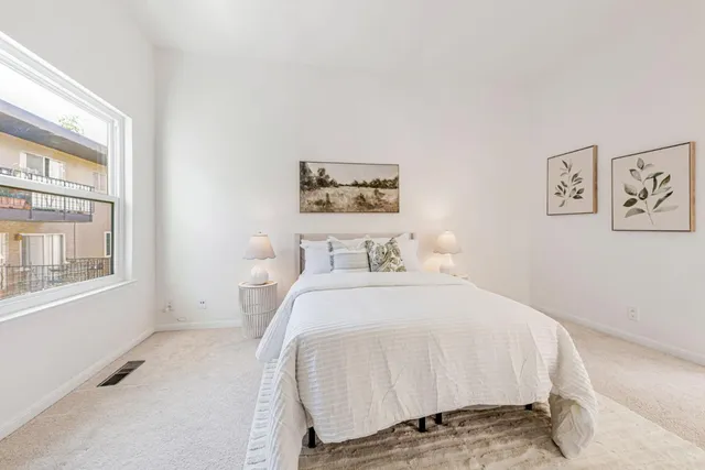 a bedroom with furniture and a large window