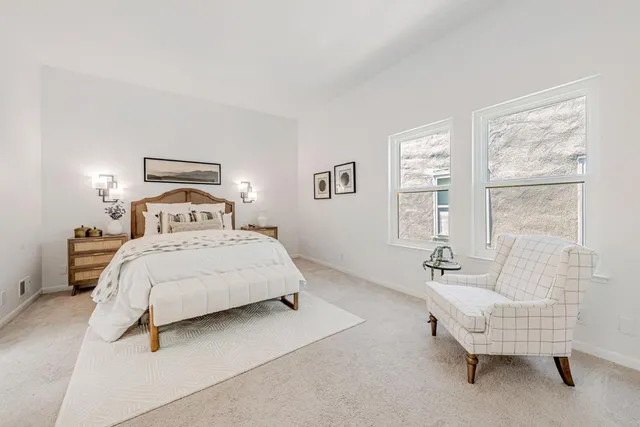 a spacious bedroom with a bed and a couch