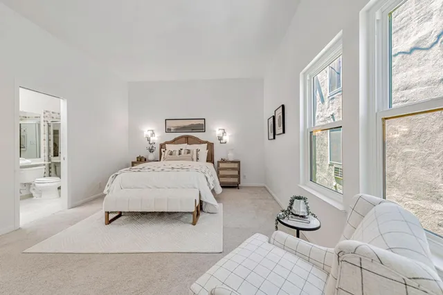 a bedroom with a bed and a mirror