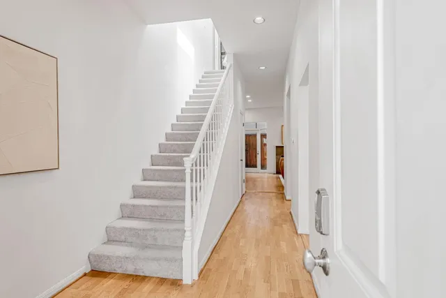 a living room with furniture a large window and a fireplace