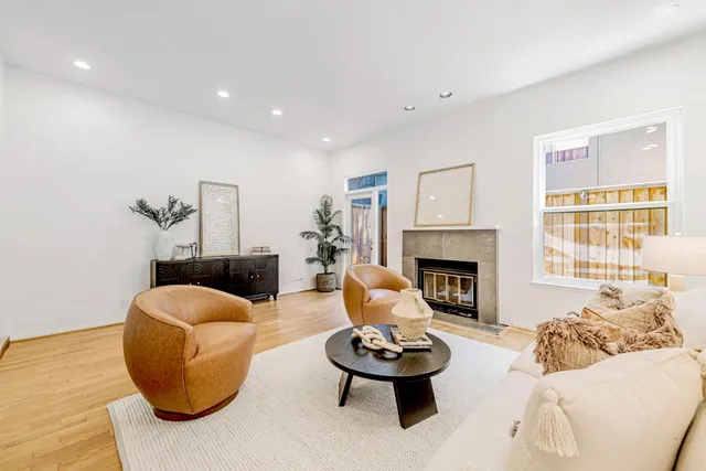 a kitchen with stainless steel appliances granite countertop a refrigerator sink and white cabinets