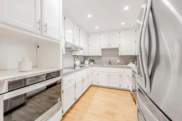 a kitchen with a refrigerator and a sink