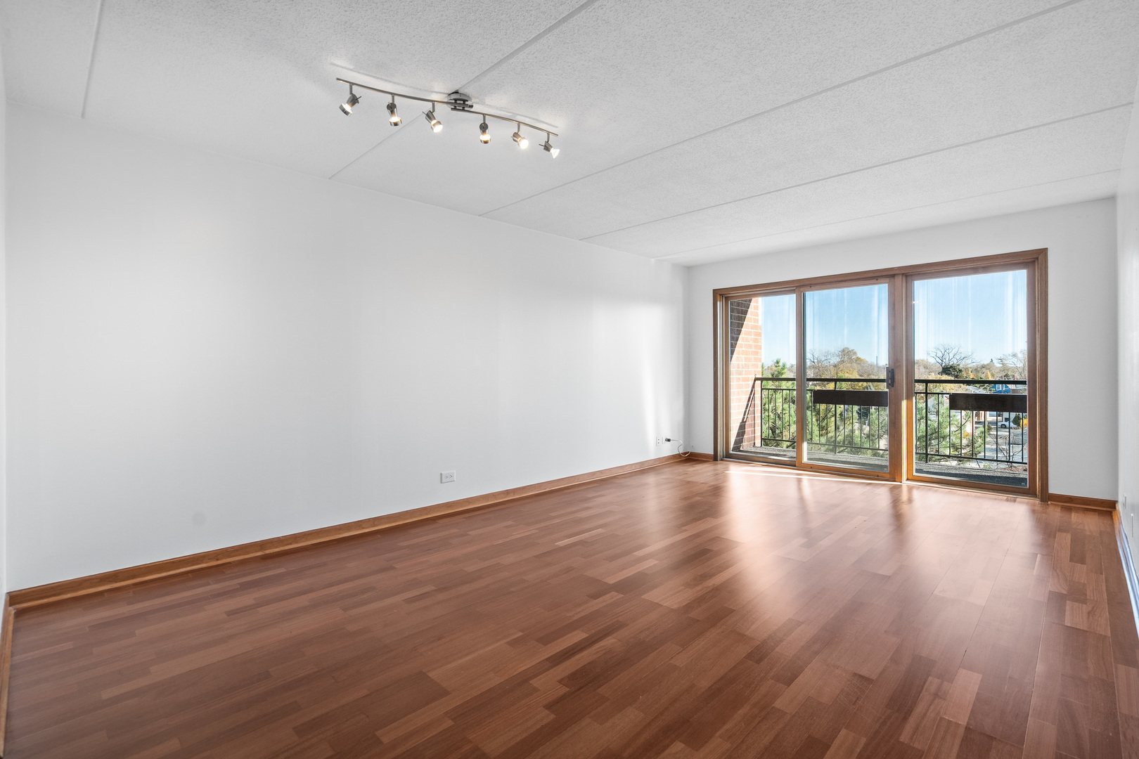 6400 West Berteau Avenue, Unit 405 Chicago, IL 60634 - Photo 11 of 22 a view of an empty room with wooden floor and a window