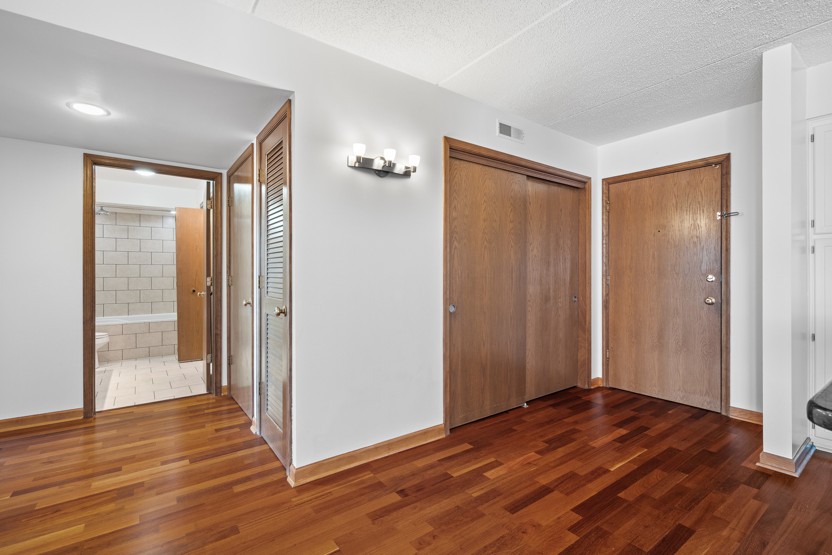 6400 West Berteau Avenue, Unit 405 Chicago, IL 60634 - Photo 12 of 22 a view of wooden floor and windows in a room
