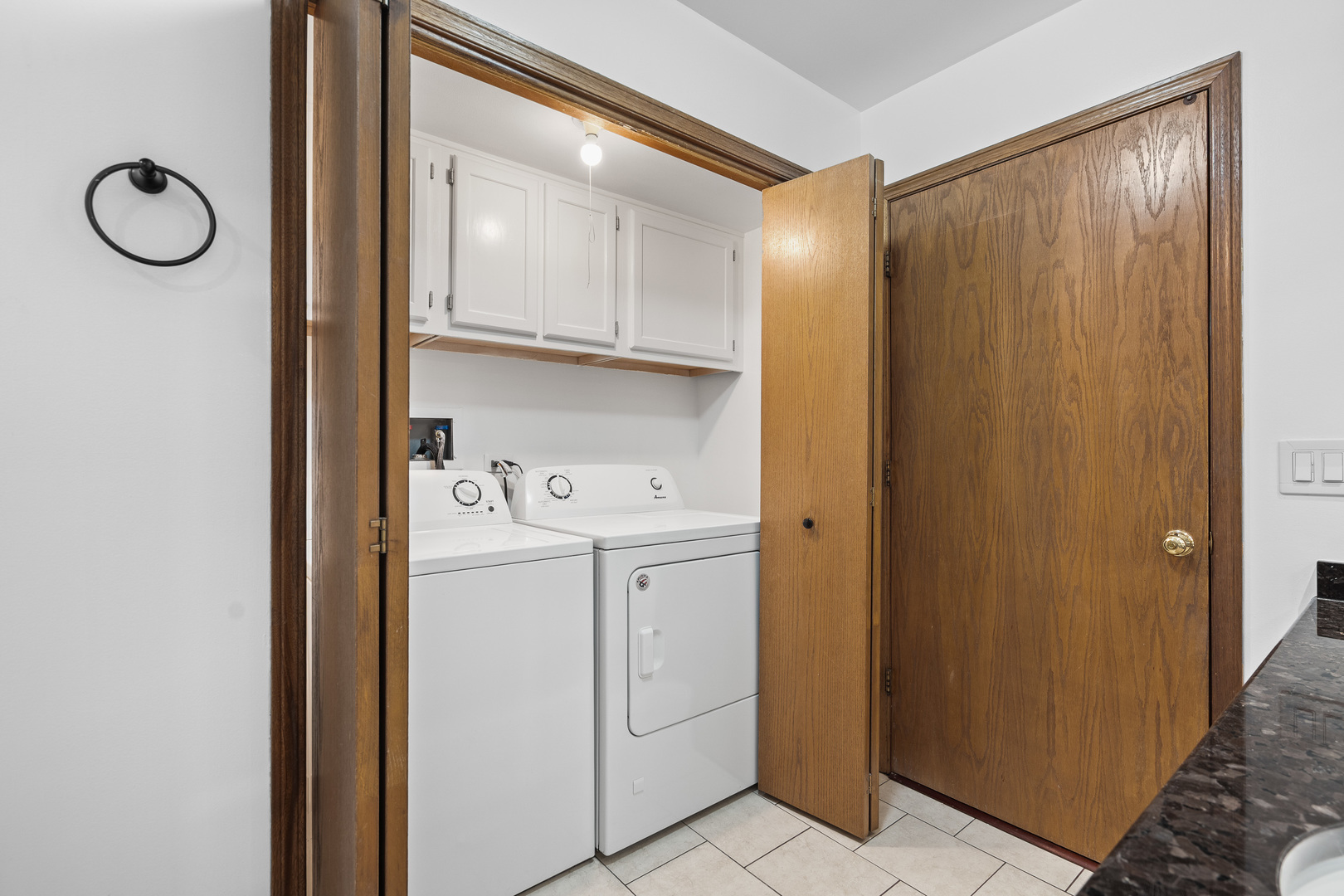 6400 West Berteau Avenue, Unit 405 Chicago, IL 60634 - Photo 16 of 22 a view of washer and dryer with kitchen in the background