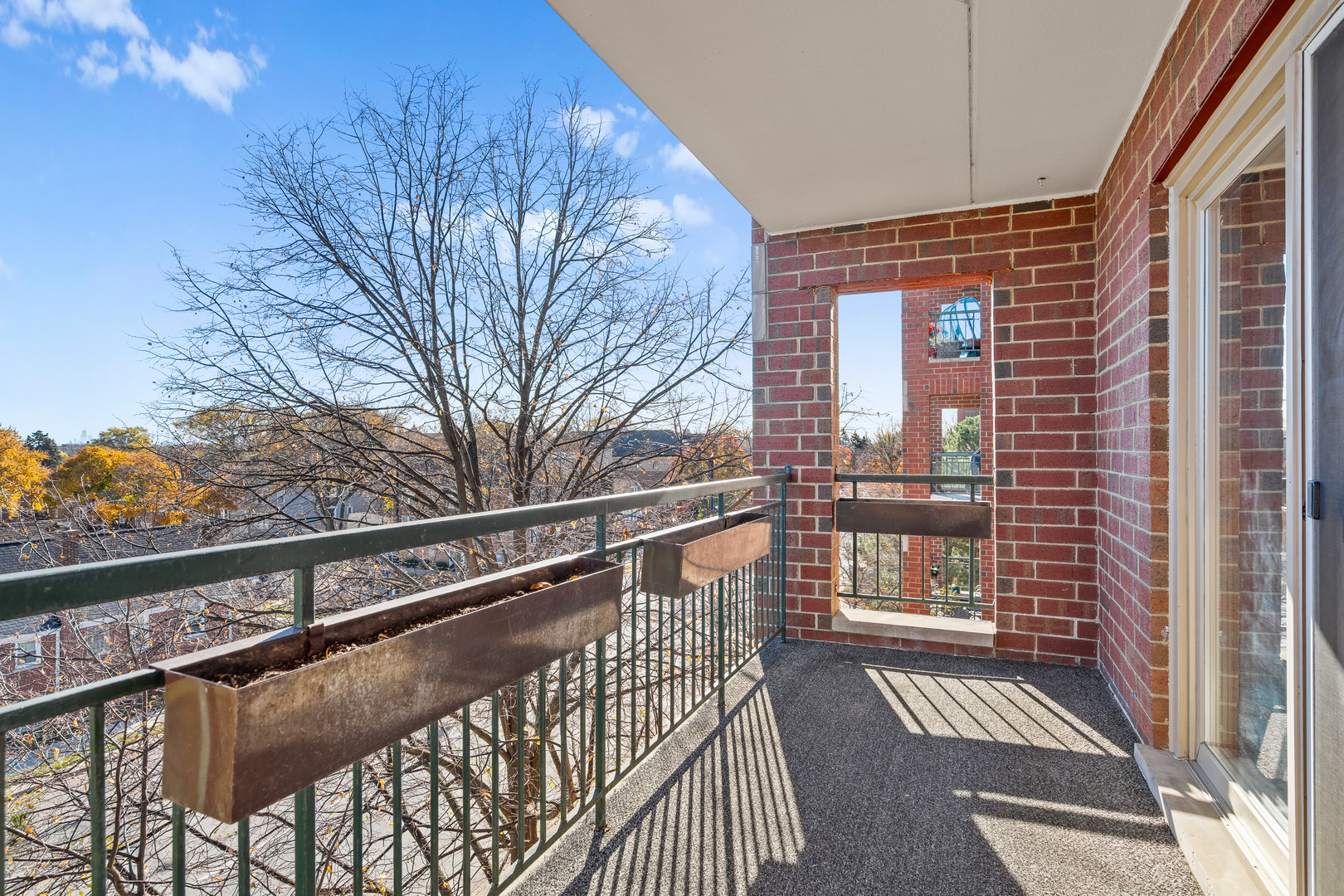 6400 West Berteau Avenue, Unit 405 Chicago, IL 60634 - Photo 17 of 22 a view of balcony with wooden floor and fence