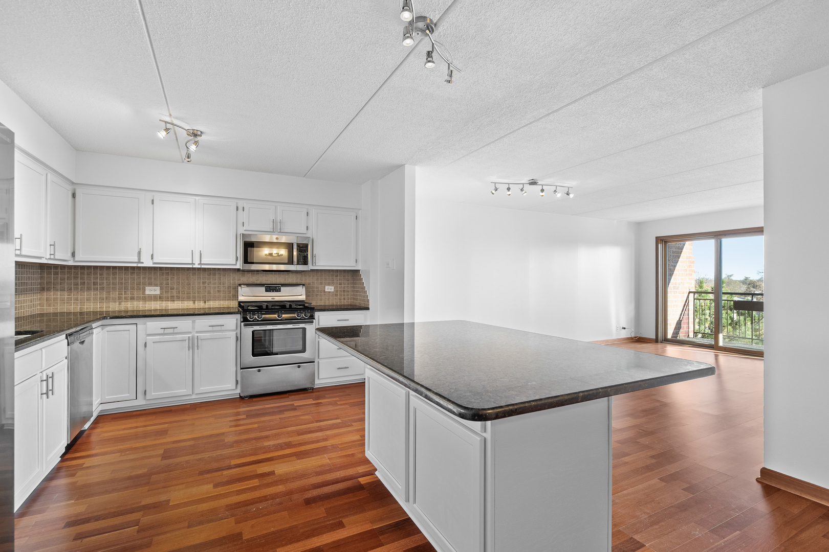 6400 West Berteau Avenue, Unit 405 Chicago, IL 60634 - Photo 6 of 22 a kitchen with stainless steel appliances granite countertop a sink stove and refrigerator