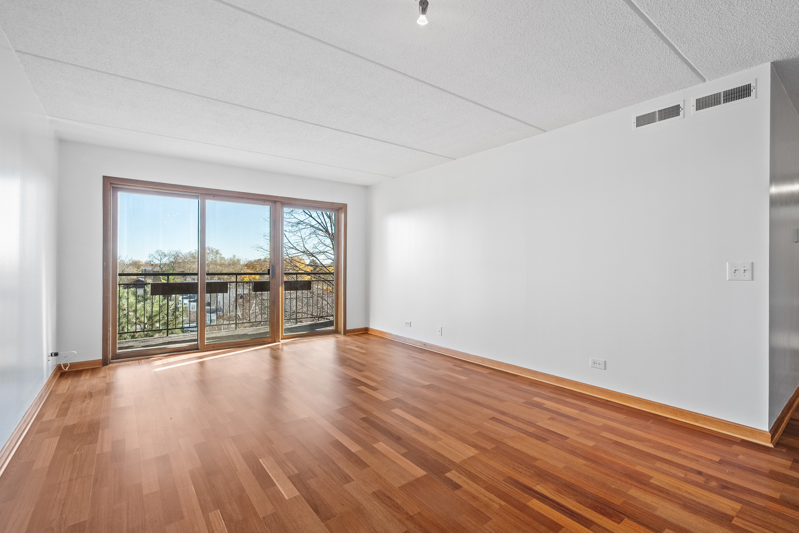 6400 West Berteau Avenue, Unit 405 Chicago, IL 60634 - Photo 10 of 22 wooden floor in an empty room with a window