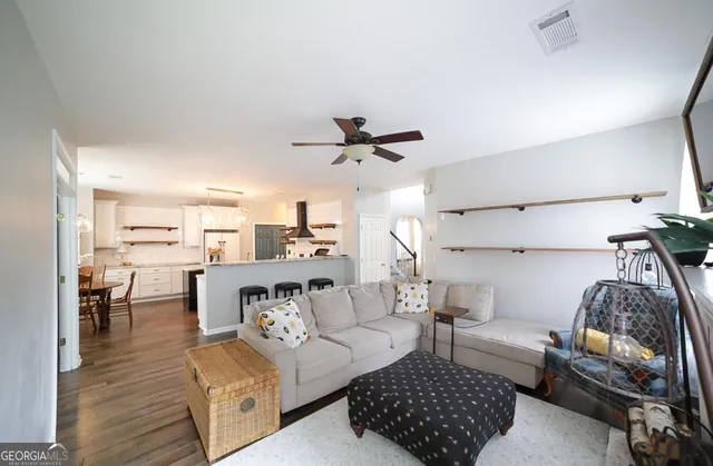 a kitchen with sink a stove and chairs