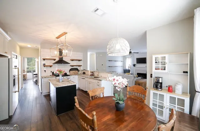a very nice looking room with a large window and chandelier