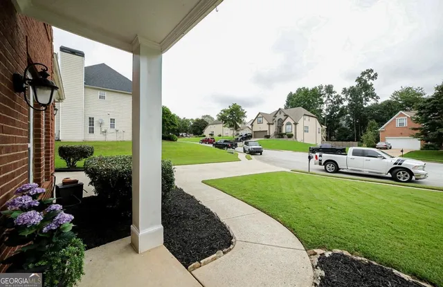 a view of entryway and hall with wooden floor